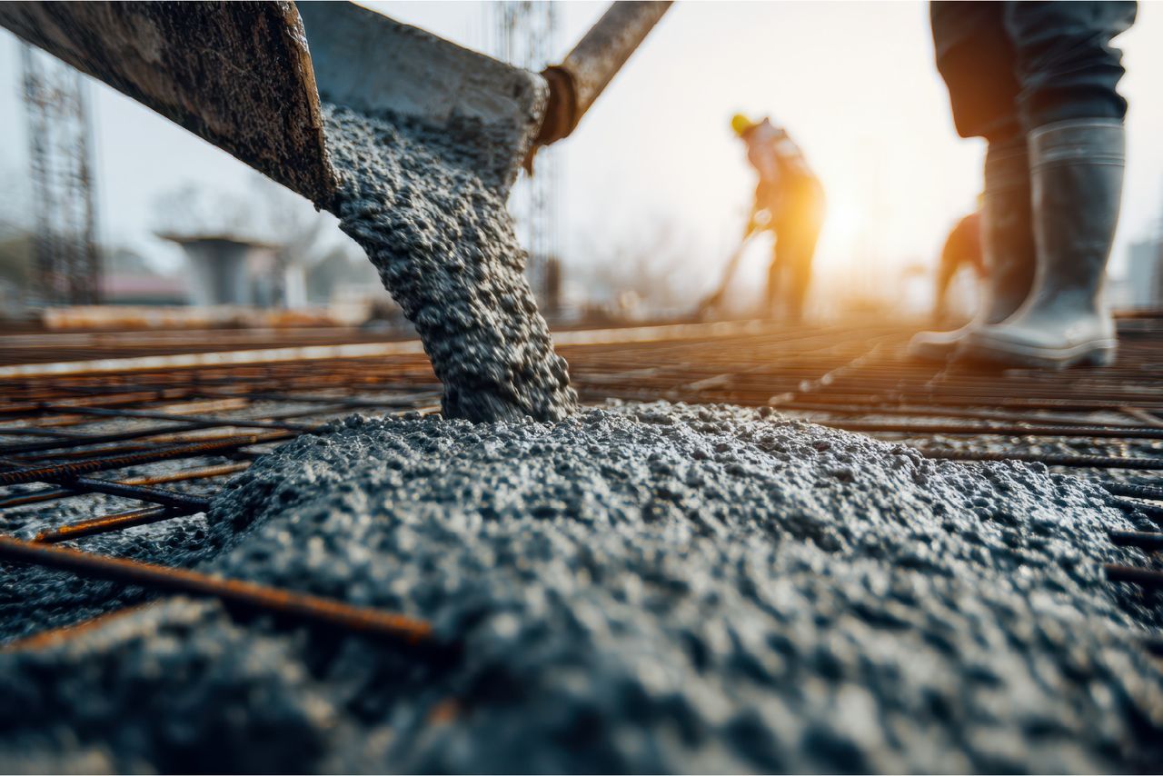 Concrete being poured over steel reinforcing on site